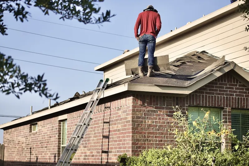 Professional roofer working on a residential roof in Keller Town Center